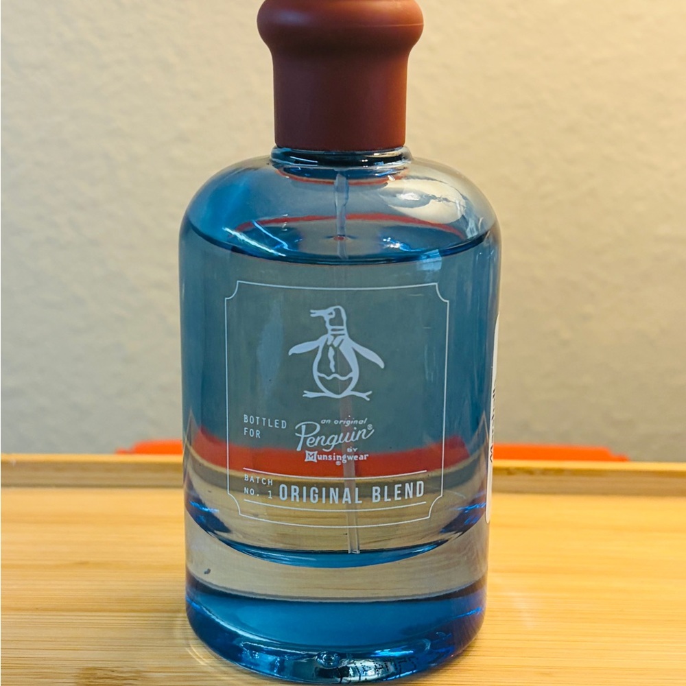 Original Penguin Body Wash Bottle with Blue Liquid and Brown Cap